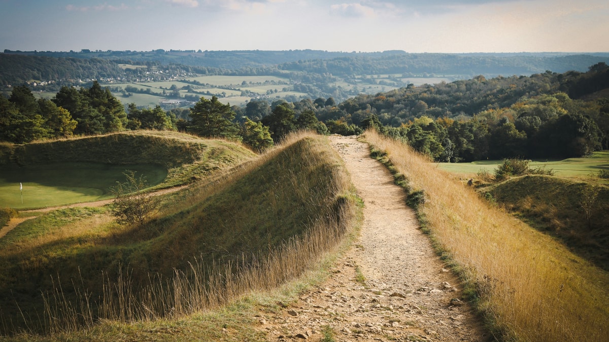 A footpath over grassy ramparts at Painswick, looking across the Cotswolds