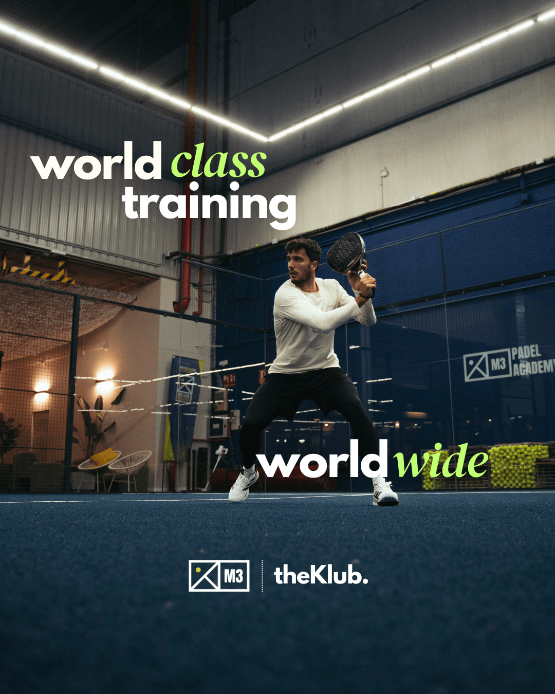 A player in a white top hitting a backhand on an indoor court at M3 Padel Academy in Madrid